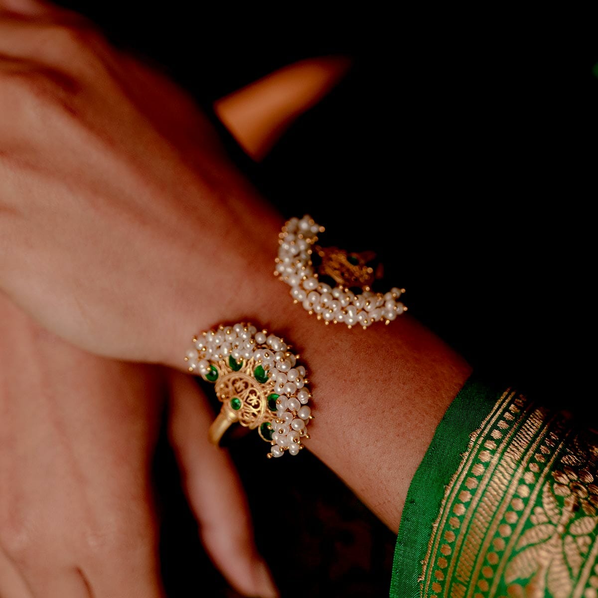 Close up indian pakistani bride hands decorated by golden henna, jewelry  bracelets and rings at mehndi sangeet party at home interior with velvet  pink Stock Photo - Alamy